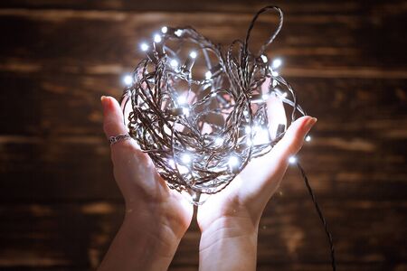 Hands holding christmas garland