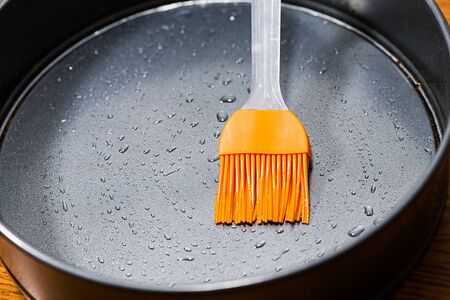 Silicon culinary brush kneading oil on baking dishの写真素材