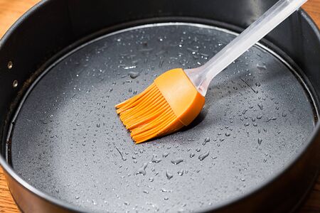 Silicon culinary brush kneading oil on baking dishの写真素材