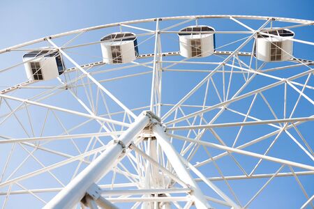 Underside view of a white ferris wheelの写真素材