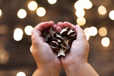 Childs hands holding wooden starsの写真素材