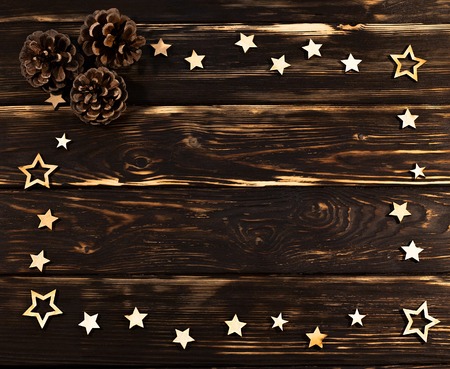 Wooden background with christmas  stars folded on the perimeter