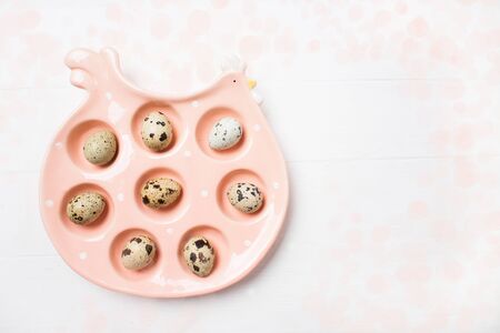 Pink ceramic chiken with eggs on soft blurred background. Easter concept