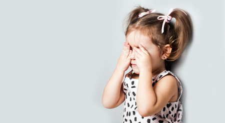 Portrait of a little girl. She is cryingの写真素材