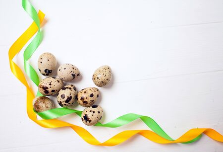 Easter eggs with colourfulll tapes on wood background, Top view with tag for copy spaceの写真素材