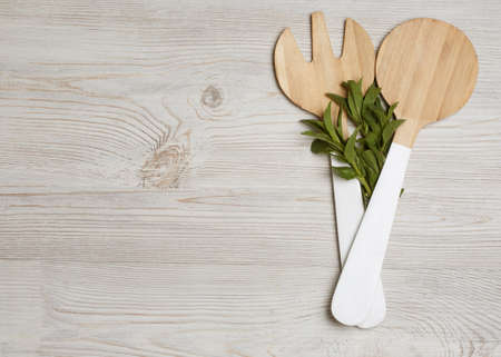 Wooden cutlery with mint leaves on wooden table. Place for your text, Top viewの写真素材