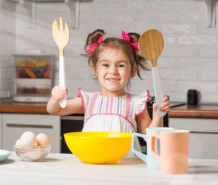 cute little girl baker on kitchen with baking ingredients, tastyの写真素材