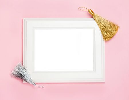 white wooden frame on pink background decorated with Decorative brush, blank space for a text. Top view, flat layの写真素材