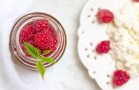 Homemade pancakes with honey, raspberries, cottage cheese with powder sugar. Flat lay, top view. copy space. eco style.の写真素材