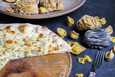 Fresh classic italian pizza with pasta and Cutlery, top view, flat layの写真素材