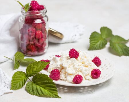 Homemade pancakes with honey, raspberries, cottage cheese with powder sugar. Flat lay, top view. copy space. eco style.の写真素材