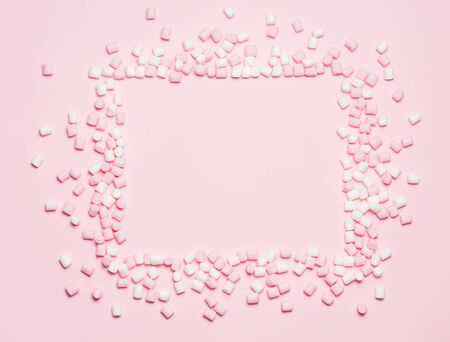 Pink and white Marshmallows frame on pink background Top view, flat lay. free space for your textの写真素材