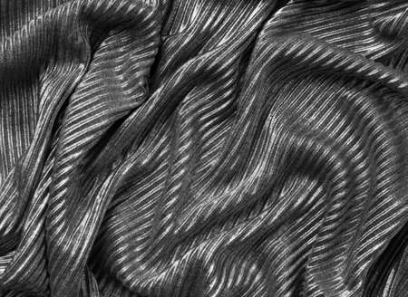 silver fabric texture, close up. black and white.
