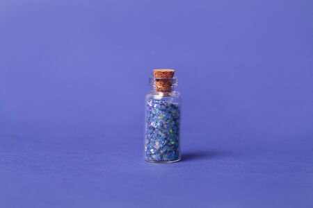 Ultra violet concept: bottle with sparkles on ultra violet background. close upの写真素材