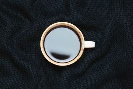 Coffee cup on wool background.