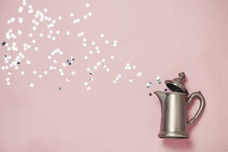 Silver stars appearence from old vintage kettle. Magic picrute, glamor. top view.の写真素材