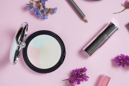 Makeup brushes set and color eye-shadow palette on pink and blue backgroundの写真素材