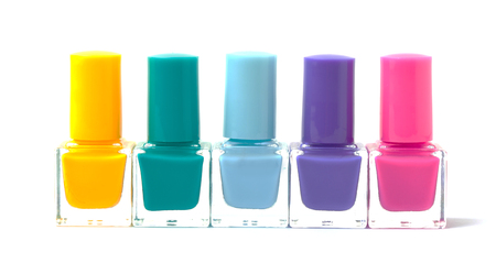 Colorful nail polishes bottles isolated on white. Cut out. Trendy manicure minimalistic concept