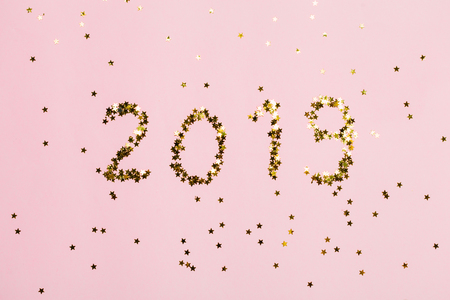 2019 new year text made from stars on pink background. Bright and festive.