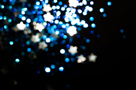 Magic lights christmas bokeh on black background. Can be used for your photos.の写真素材