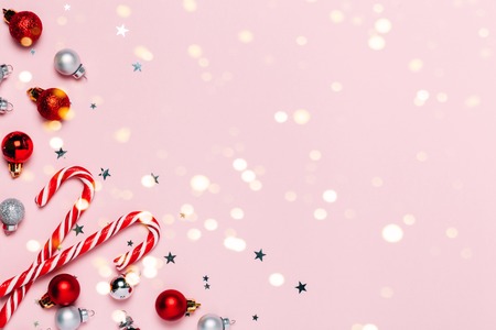 Christmas background with decorations and red Christmas candies. Top view, flat lay. Bright and festive greeting card.の写真素材