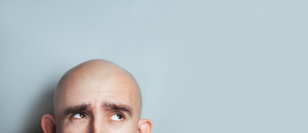 Emotional portrait of surprised bald man. half-face. Copyspace for text.の素材 [FY310116342842]