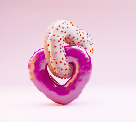 couple of heart-shaped donuts on pink pastel background. Valentine's concept. Copyspace fot text.の写真素材
