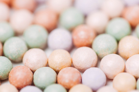 Multicoloured corrector face powder balls for make up isolated on white.の写真素材