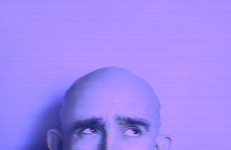 Neon glitch effect portrait of bald man.の写真素材
