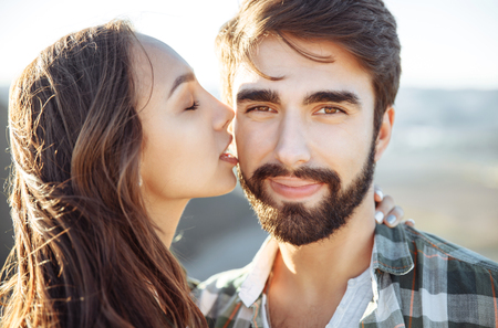 Young beautiful couple walking outside on beautiful sunset.の写真素材