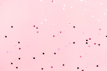 Pink confetti and stars and sparkles on pink background. Top view, flat lay. Copyspace for text....
