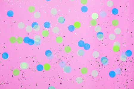 Pink confetti background. Top view, flat lay.