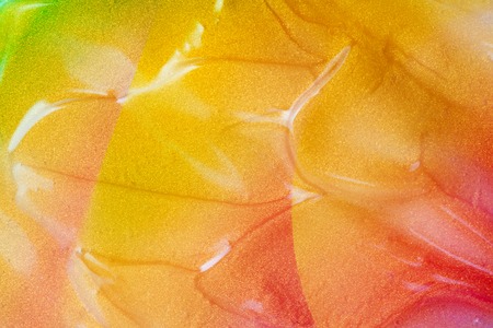 vaporwave style texture background: neon orange funky paint wave texture. Close up, flat lay.