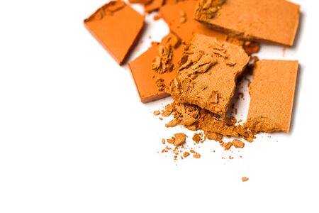 A broken orange eye shadow smear make up palette isolated on a white background. Top view, flat lay. Copy space for your textの写真素材