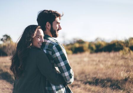 Young beautiful couple walking outside on beautiful sunset.の写真素材