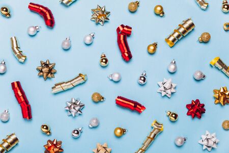 Christmas blue background with golden decorations put as frame on blue background. Bright and festive flat lay. Top view, Copyspace for text. Greetings for christmas or new year.の写真素材