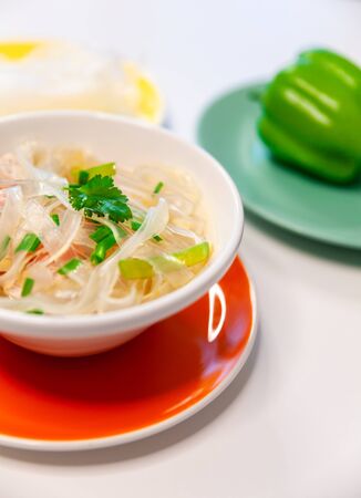 Soup with cellophane noodles, chicken and sweet green pepper.の写真素材