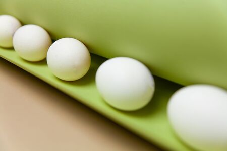 Creative Easter beige and pink background with white eggs.の写真素材