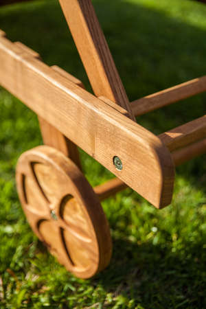 deck chair wooden wheel on green grass.の写真素材