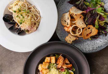 Different italian traditional dishes and salads on table.の写真素材