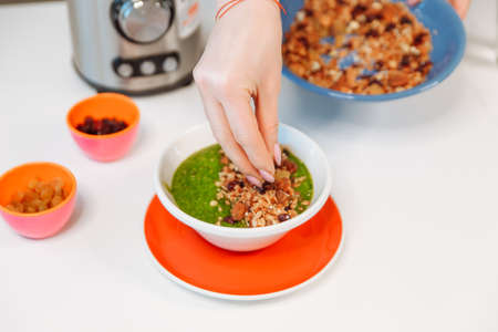 fresh greens and granola smoothie on white table. Healthy vegan food.の写真素材