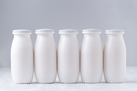 five bottles of drink yogurt on gray backgroundの写真素材
