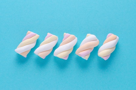 marshmallow in pastel colors on blue background