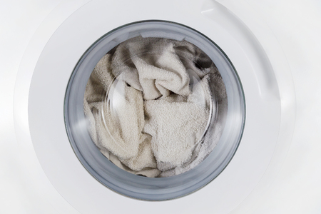 white clothes wash, closed washing machine with towel closeupの写真素材