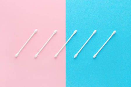white cotton swabs on pink and blue backgroundの写真素材