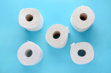 white toilet paper rolls on blue backgroundの写真素材