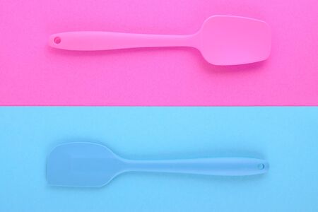 bright kitchen utensils on pink and blue background, creative idea