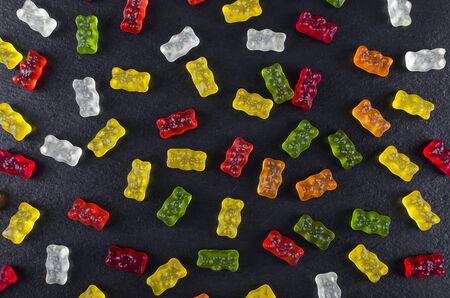 colorful jelly candy on black background, flat lay