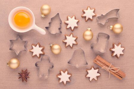 ingredients with kitchen tools for dessert baking and star cookies on baking paperの写真素材