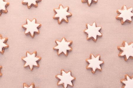 christmas cookies background on baking paper, flat lay